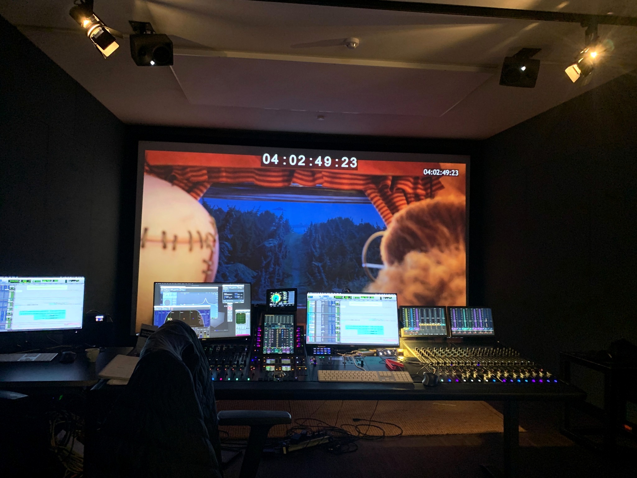 Film sound mixing studio with cinema screen and mixing console