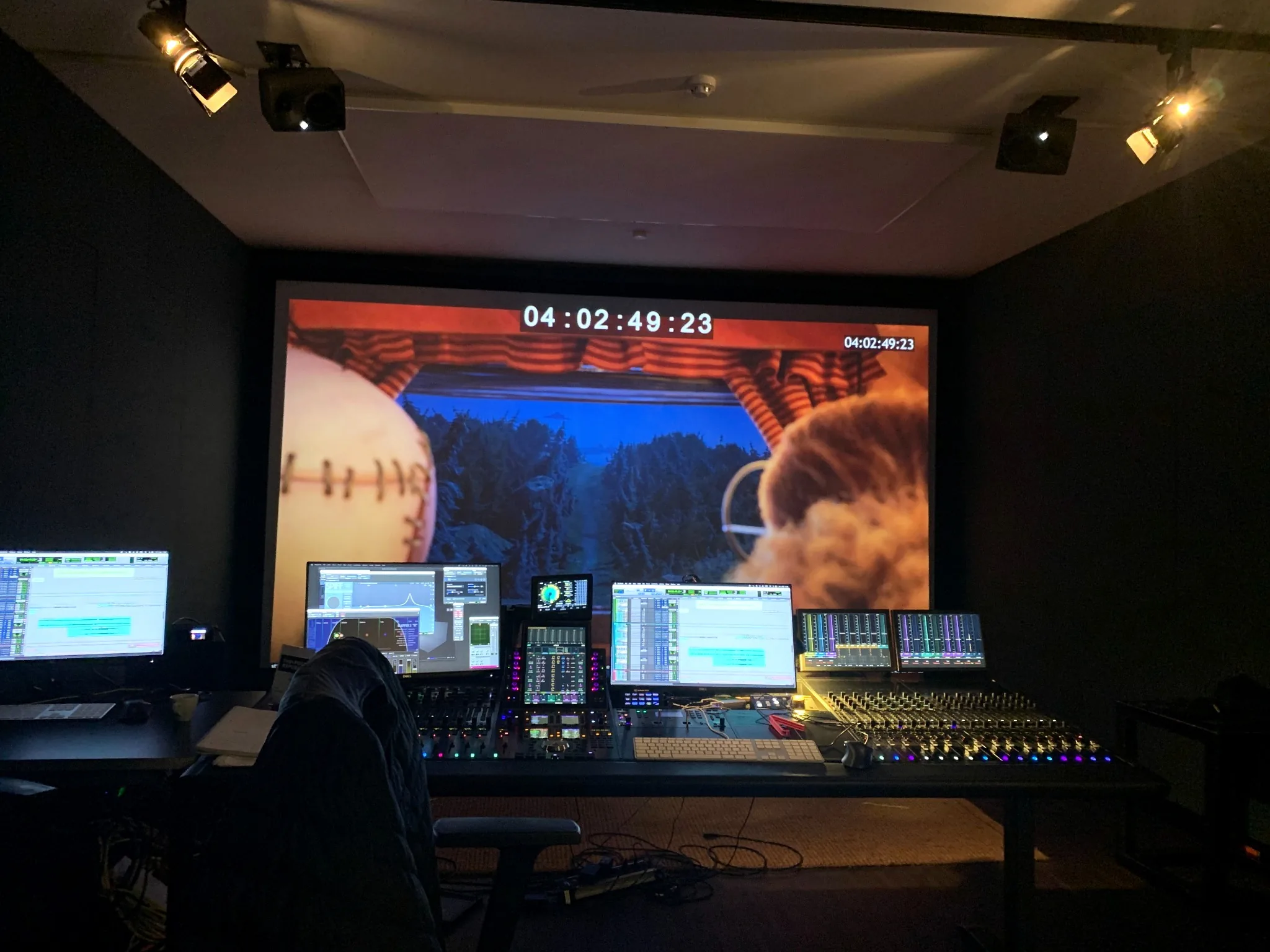 Film sound mixing studio with cinema screen and mixing console